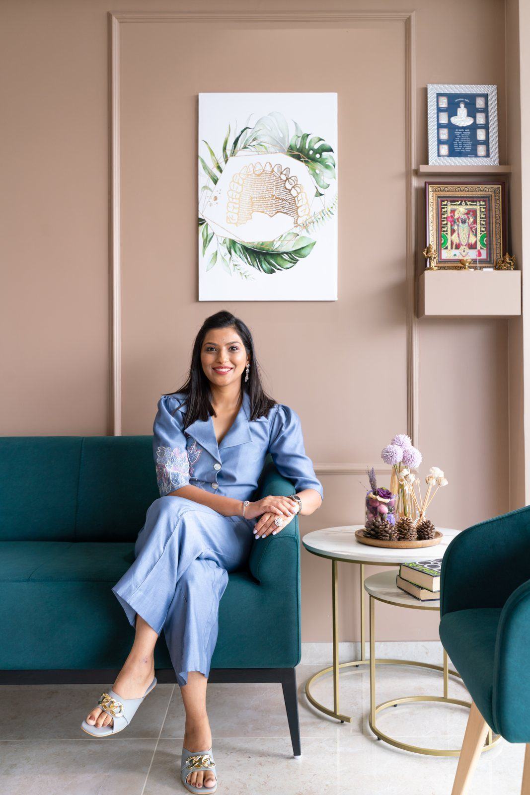 Dr. Shreya seated by green chairs in clinic